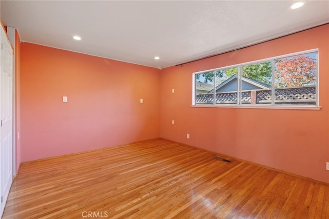 empty room with light hardwood / wood-style flooring