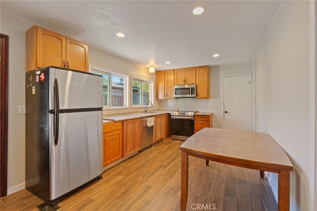 kitchen featuring sink, stainless steel appliances, and light hardwood / wood-style floors