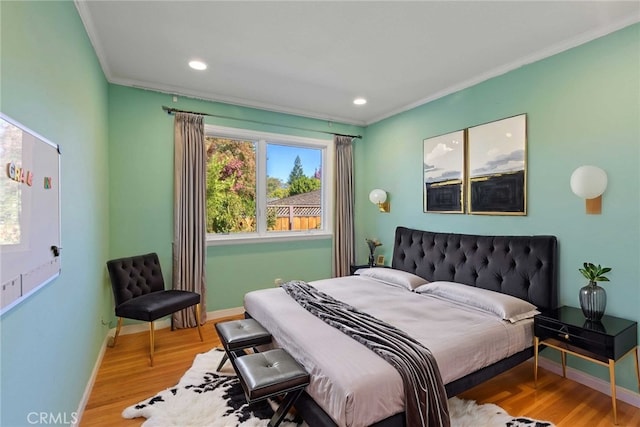 bedroom featuring hardwood / wood-style flooring and crown molding