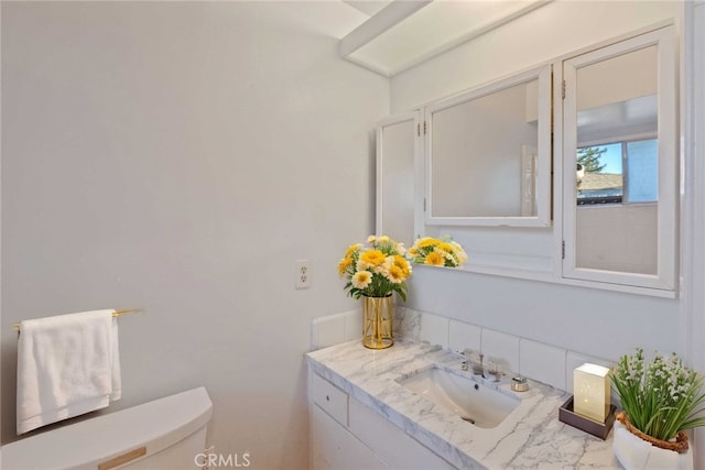 bathroom with vanity and toilet