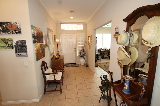 foyer featuring light tile patterned floors and crown molding