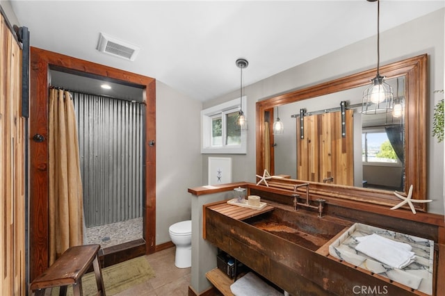 bathroom with tile patterned floors, a shower with curtain, and toilet