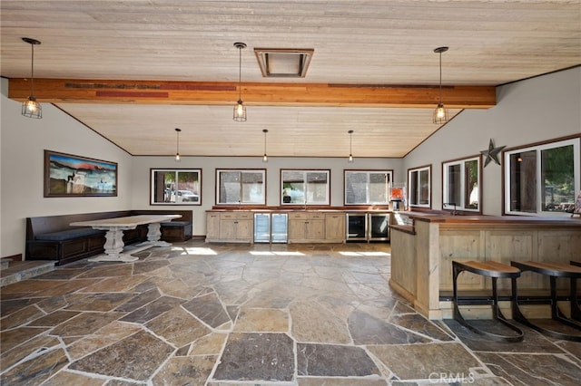 kitchen featuring wood ceiling, lofted ceiling with beams, and decorative light fixtures