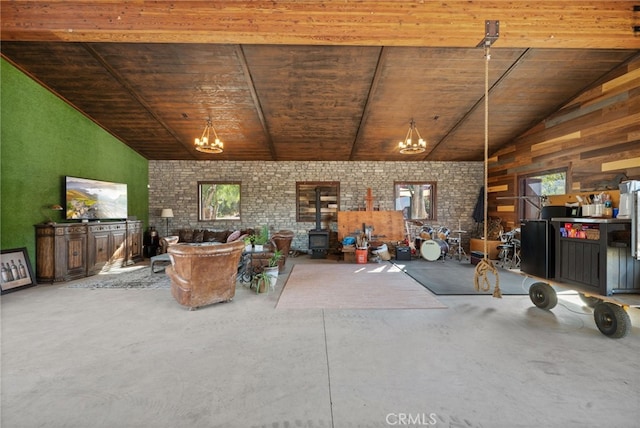 unfurnished living room with wooden ceiling, brick wall, plenty of natural light, concrete floors, and lofted ceiling