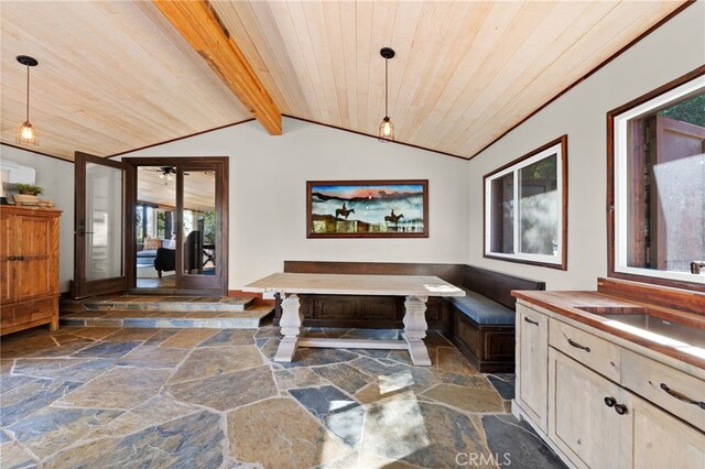 dining space with lofted ceiling with beams, wood ceiling, sink, and french doors