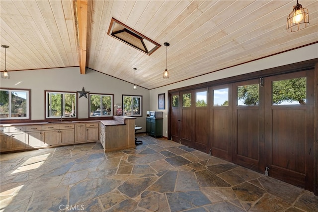 interior space with beam ceiling, sink, wooden ceiling, and hanging light fixtures