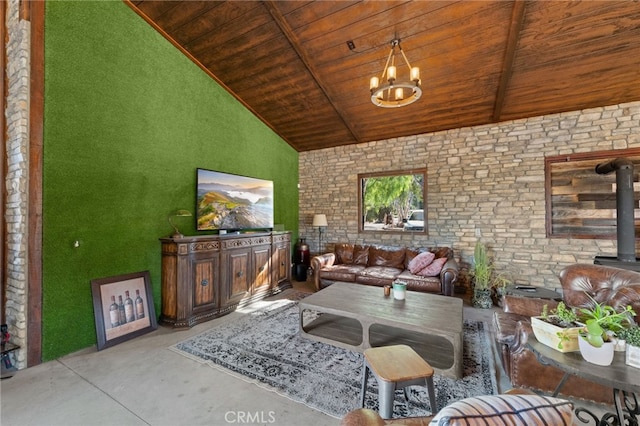 unfurnished living room featuring a chandelier, a wood stove, high vaulted ceiling, and wood ceiling