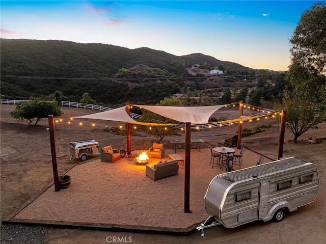 playground at dusk with a mountain view and an outdoor fire pit