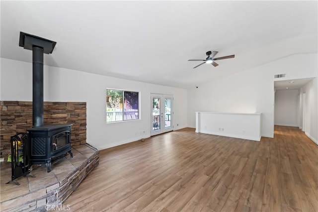 unfurnished living room with ceiling fan, wood-type flooring, french doors, and lofted ceiling