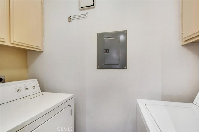 laundry area featuring cabinets, independent washer and dryer, and electric panel