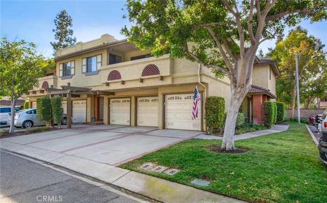 townhome / multi-family property with a garage and a front lawn