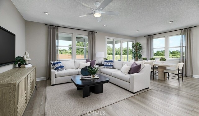 living room featuring a textured ceiling, light hardwood / wood-style flooring, and ceiling fan