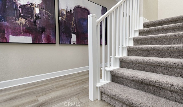 stairs with hardwood / wood-style floors