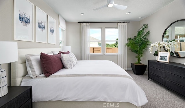 bedroom with ceiling fan and light carpet