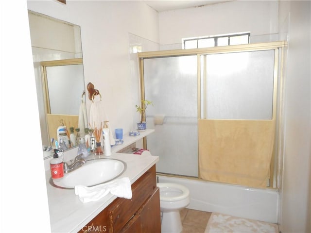 full bathroom with toilet, vanity, tile patterned floors, and enclosed tub / shower combo