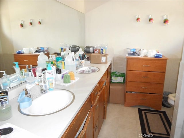 bathroom featuring tile patterned flooring and vanity