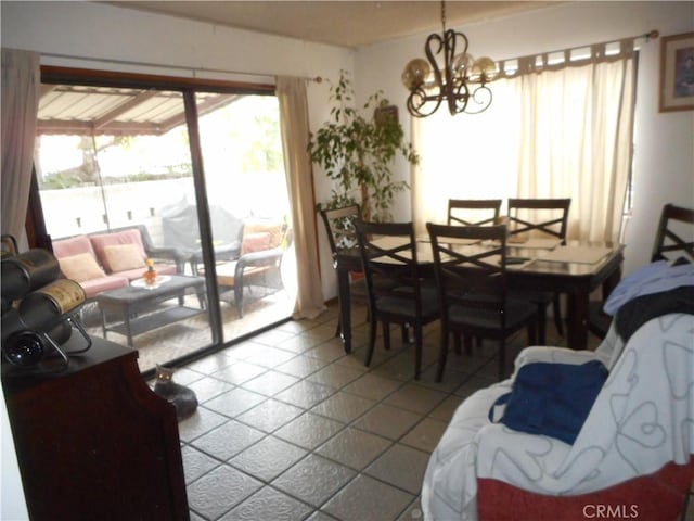 dining area with tile patterned flooring and a chandelier