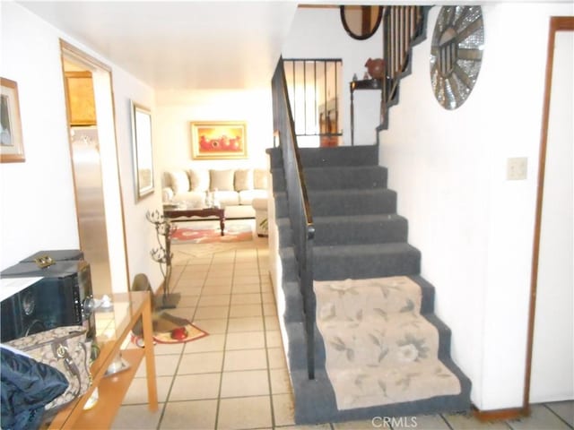 stairs with tile patterned flooring