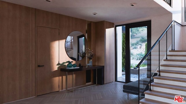 foyer entrance featuring parquet flooring