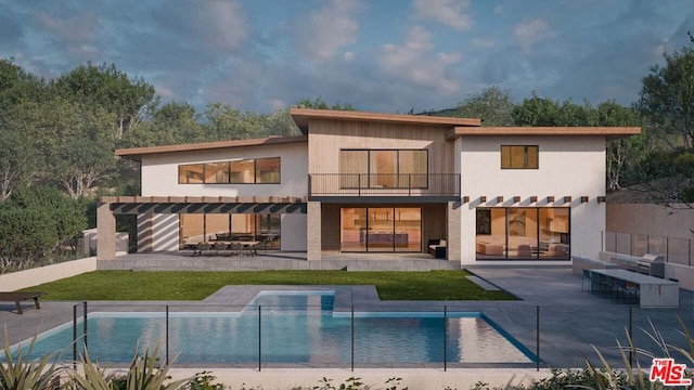 rear view of house with a patio, a balcony, and a lawn