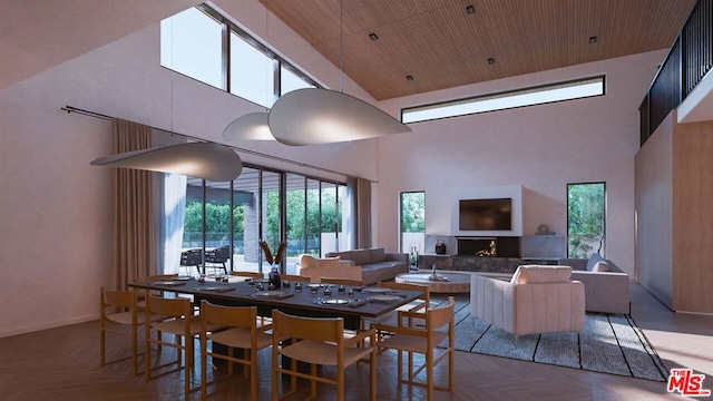 dining room with wood ceiling, a towering ceiling, and parquet floors