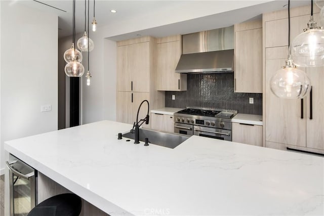 kitchen with light brown cabinets, range with two ovens, wall chimney range hood, tasteful backsplash, and a kitchen bar