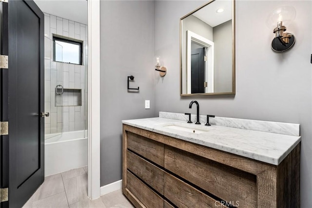 bathroom with tile patterned floors, tiled shower / bath combo, and vanity