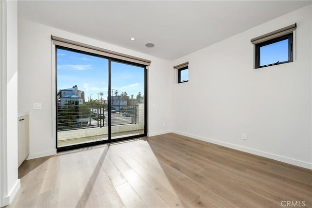 spare room with light hardwood / wood-style floors