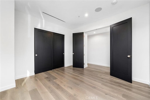 unfurnished bedroom with light wood-type flooring