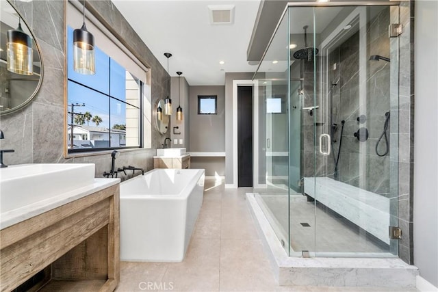 bathroom featuring tile patterned floors, vanity, and plus walk in shower