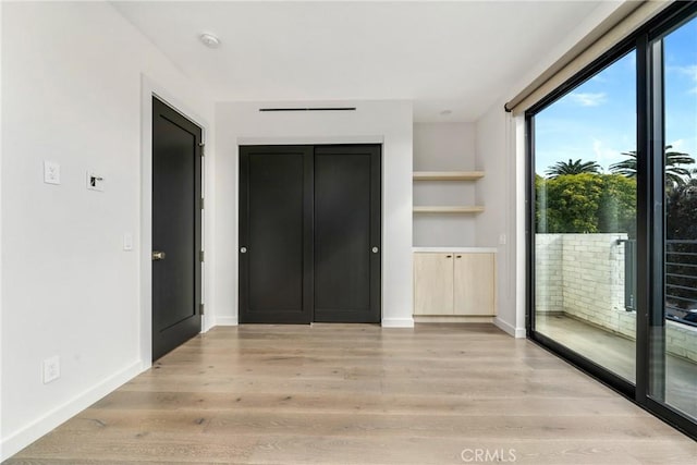 interior space with access to outside and light hardwood / wood-style flooring