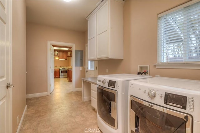 laundry area featuring washer and clothes dryer and cabinets