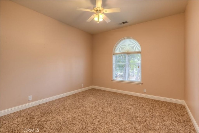 empty room with ceiling fan and carpet