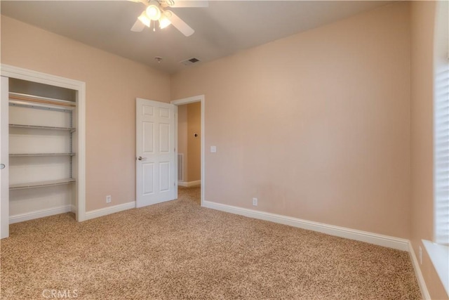 unfurnished bedroom featuring light colored carpet, a closet, and ceiling fan