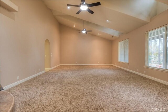 carpeted empty room featuring high vaulted ceiling and ceiling fan