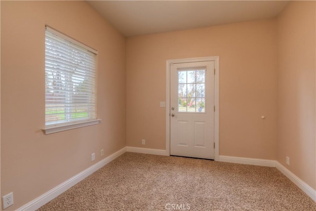 doorway to outside with carpet floors