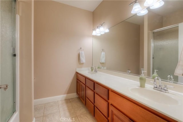 bathroom featuring vanity, a shower with shower door, and tile patterned flooring