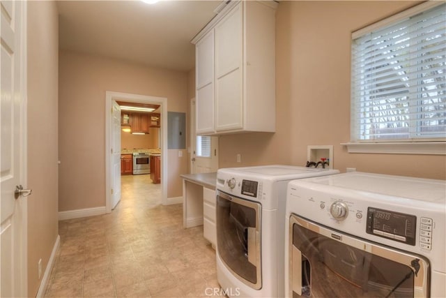 laundry area with separate washer and dryer and cabinets