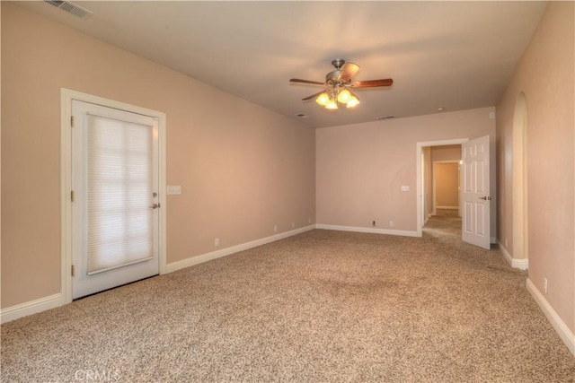 carpeted spare room with ceiling fan