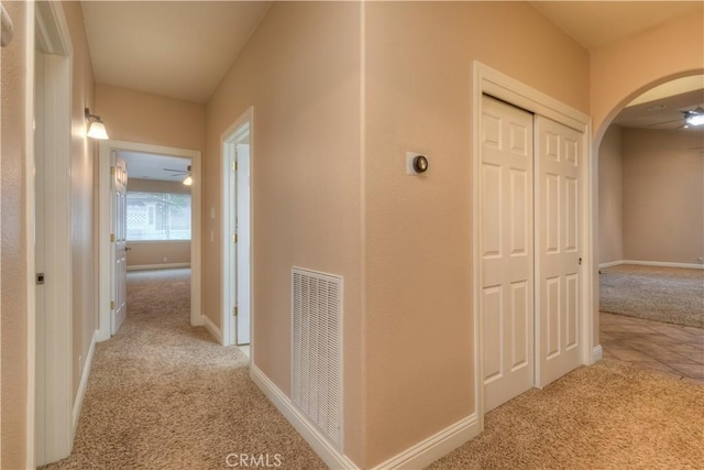 corridor featuring light colored carpet