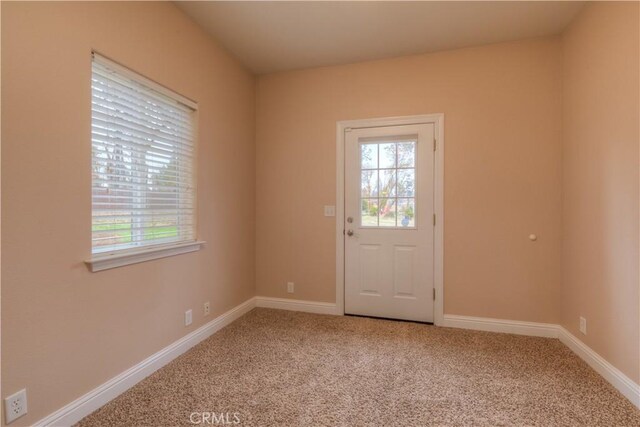 doorway to outside with carpet floors