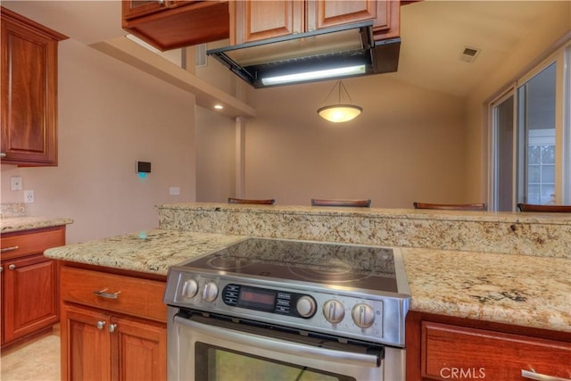 kitchen featuring light stone counters and electric stove