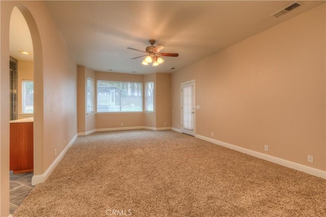 carpeted empty room with ceiling fan