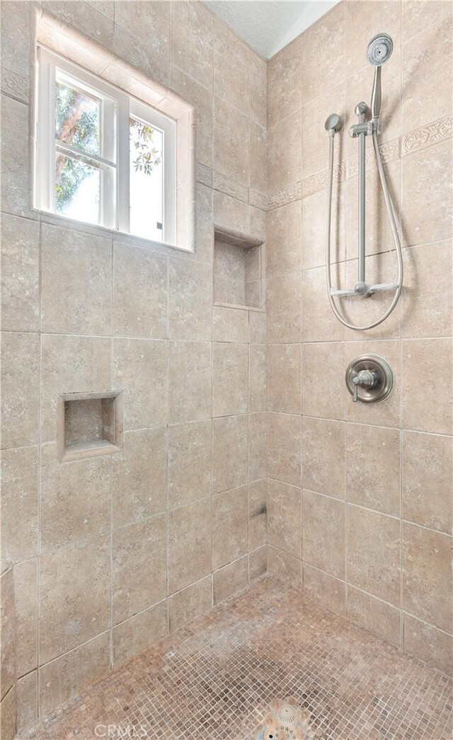 bathroom with a tile shower