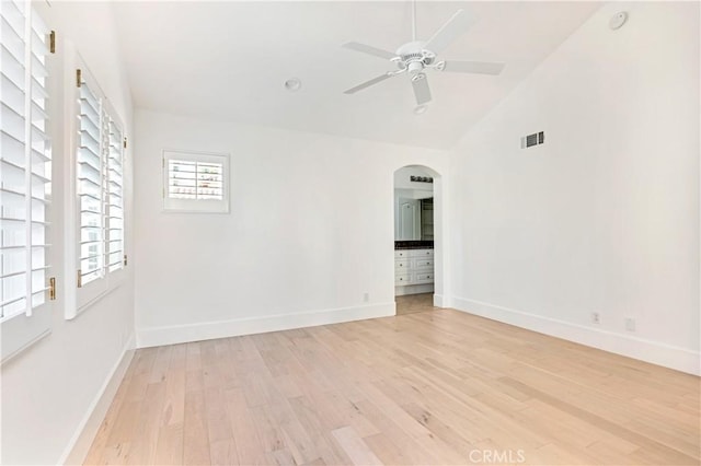 unfurnished room featuring ceiling fan, lofted ceiling, and light wood-type flooring