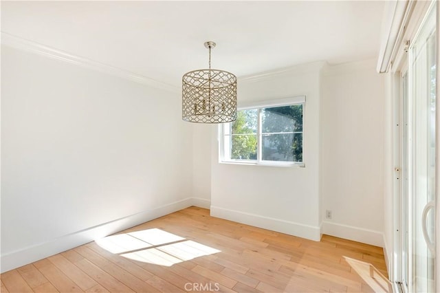 unfurnished dining area featuring light wood-type flooring and crown molding