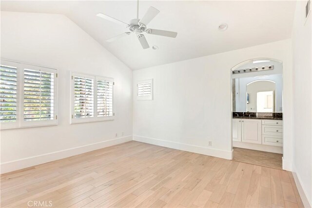 spare room with ceiling fan, high vaulted ceiling, and light hardwood / wood-style floors