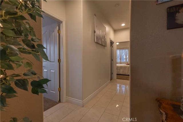 hall featuring light tile patterned floors