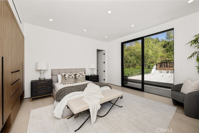 bedroom with access to exterior and light wood-type flooring