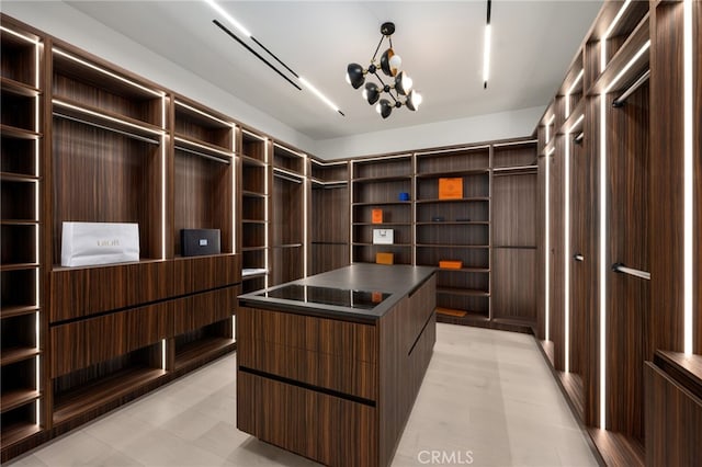 walk in closet featuring a notable chandelier